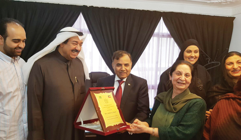 Yasmeen Mozaffar is seen with her students, Pakistani Ambassador to Kuwait Ghulam Dastaghir and Kuwaiti partner Jaber Al-Enezy.