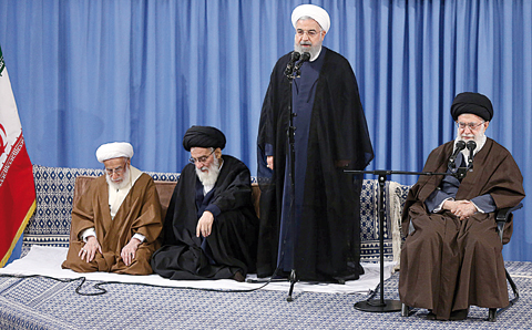 TEHRAN: Iran’s Supreme Leader Ayatollah Ali Khamenei (right) listens to a speech by Iranian President Hassan Rouhani (center), in the presence of Iranian Guardian Council head Ayatollah Ahmad Jannati (left), and Ayatollah Mahmoud Hashemi Shahroudi (2nd-left) Chairman of Expediency Discernment Council, during a ceremony in Tehran. —AFP
