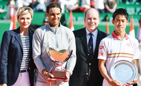 MONACO: Princess Charlene (L) and her husband Prince’s Albert II of Monaco (2nd R) stand with Spain’s Rafael Nadal (2nd L) as he holds the winner’s trophy and Japan’s Kei Nishikori (R) following their final match in the Monte- Carlo ATP Masters Series tournament on April 22, 2018, in Monaco. — AFP