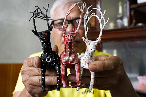 CORRECTION - This picture taken on April 24, 2018 shows Nguyen Truong Chinh displaying intricately crafted animals made from plastic bags by his son and death row inmate Nguyen Van Chuong, during an interview with AFP at his home in Hai Duong.nThe palm-sized creations that death row inmates have furtively made and smuggled out of their solitary cells offer a rare glimpse of prison life in Vietnam, believed to be one of the world's leading executioners. / AFP PHOTO / Nhac NGUYEN / TO GO WITH Vietnam-prison-deathrow-rights-art,FEATURE by Jenny Vaughan with Tran Thi Minh Ha / “The erroneous mention[s] appearing in the metadata of this photo by Nhac NGUYEN has been modified in AFP systems in the following manner: [Hai Duong] instead of [Hanoi]. Please immediately remove the erroneous mention[s] from all your online services and delete it (them) from your servers. If you have been authorized by AFP to distribute it (them) to third parties, please ensure that the same actions are carried out by them. Failure to promptly comply with these instructions will entail liability on your part for any continued or post notification usage. Therefore we thank you very much for all your attention and prompt action. We are sorry for the inconvenience this notification may cause and remain at your disposal for any further information you may require.”