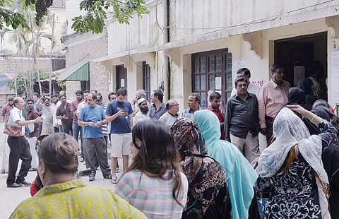 BANGALORE: Indian voters queue to cast their ballots in the Karnataka Legislative Assembly Elections at a polling station in Bangalore yesterday. —AFP