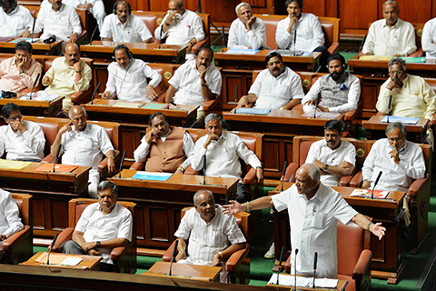 Chief Minister B.S. Yediyurappa (bottom R) of the Bharatiya Janata (BJP) party addresses the Karnataka State Legislative Assembly session before resigning from his post at Vidhana Soudha in Bangalore on May 19, 2018.nThe chief minister of a key Indian state plunged into a political crisis that saw Supreme Court hearings and accusations of bribery quit May 19 after admitting he did not have enough support to form a government. B.S. Yeddyurappa of the Hindu nationalist Bharatiya Janata Party (BJP) stepped down after just two days in the post and minutes before he was to have faced a vote of confidence in the Karnataka state assembly.n / AFP PHOTO / MANJUNATH KIRAN