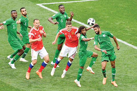 Saudi Arabia's midfielder Salman Al-Faraj (R) and defender Yasser Al-Shahrani (2nd R) compete for the ball during the Russia 2018 World Cup Group A football match between Russia and Saudi Arabia at the Luzhniki Stadium in Moscow on June 14, 2018. / AFP PHOTO / Mladen ANTONOV / RESTRICTED TO EDITORIAL USE - NO MOBILE PUSH ALERTS/DOWNLOADS