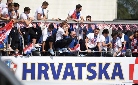 ZAGREB: Croatian national football team members ride an open-roof coach in Zagreb International Airport yesterday after their return from the FIFA World Cup 2018 in Russia in Zagreb International Airport on July 16, 2018. - AFP n