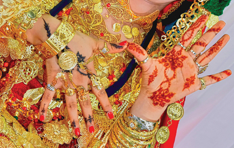 Bride shows her Henna painted hands, the day before their wedding in Gabes town, in southeastern Tunisia. — AFP