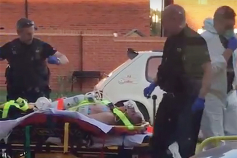 AMESBURY: A still image taken from video footage recorded shows a man on a stretcher being put into an ambulance by medics and police outside a residential address in Amesbury, southern England. — AFP