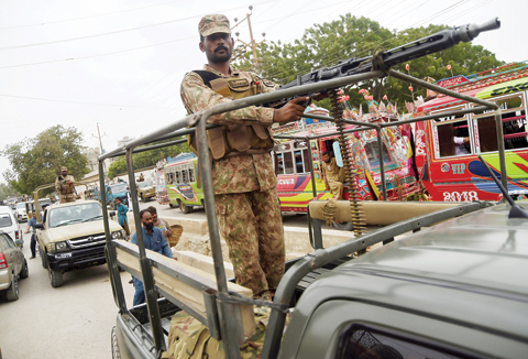 KARACHI: Pakistani soldiers patrol on a street in the port city of Karachi. — AFP