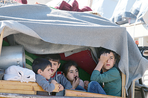 ARSAL: Syrian children ride a truck carrying their personal belongings at a Lebanese army checkpoint in Wadi Hmeid in the Bekaa valley, after leaving the village of Arsal to return to their homes in Syria’s Qalamoun region. —A