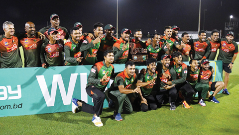 FORT LAUDERDALE: Bangladesh’s players pose with the trophy after winning the 3rd and final T20i match against West Indies at Central Broward Regional Park Stadium in Fort Lauderdale on August 5, 2018. — AFP