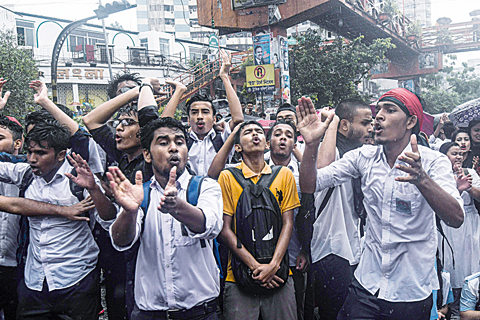 DHAKA: Bangladeshi students block a road during a protest yesterday following the deaths of two college students in a road accident. —AFP
