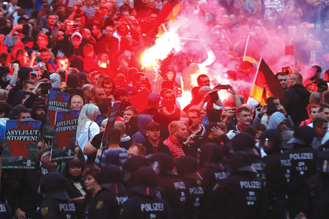 SAXONY: Right wing demonstrators light flares in Chemnitz, eastern Germany, following the death of a 35-year-old German national who died in hospital after a ‘dispute between several people of different nationalities”, according to the police. – AFP nn