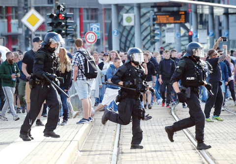 SAXONY: Riot police cross the street as a city festival was cancelled in Chemnitz, eastern Germany, after a 35-yearold German national died in hospital following a ‘dispute between several people of different nationalities’. — AFP