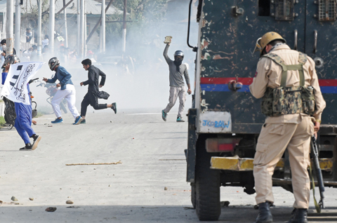 KASHMIR: Kashmiri protestors clash with Indian government forces after Eid prayers in downtown Srinagar. — AFP