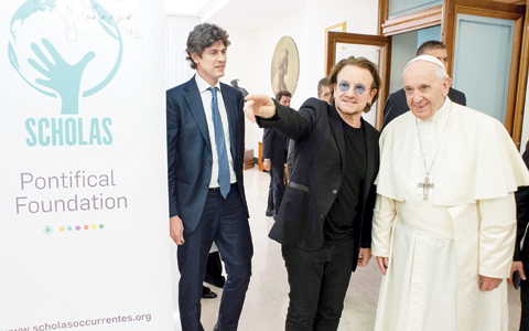 This handout photo taken and released by the Vatican Media, shows Pope Francis (right) welcoming Irish band U2 Paul David Hewson, known by his stage name Bono, prior their meeting at Vatican.-AFP