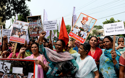 Indian women hold placards and chant slogans during protest march to demand the immediate arrest of Roman Catholic church Bishop Franco Mullackal, who is accused of raping a nun, in Jalandhar on September 12, 2018. Indian police on September 12 summoned for questioning a bishop accused by a nun of raping her multiple times, following days of protests by other nuns and supporters. Bishop Franco Mullackal, who has rejected the accusations, has been called for questioning in the southern state of Kerala on September 19, the Press Trust of India reported. / AFP PHOTO / 