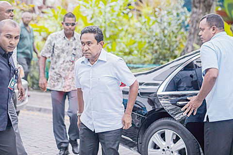 MALE: Maldives President Abdulla Yameen (center) arrives at a polling station in the capital Male yesterday. —AFP