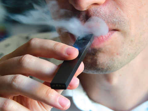 WASHINGTON: An illustration shows a man exhaling smoke from an electronic cigarette in Washington, DC. — AFP