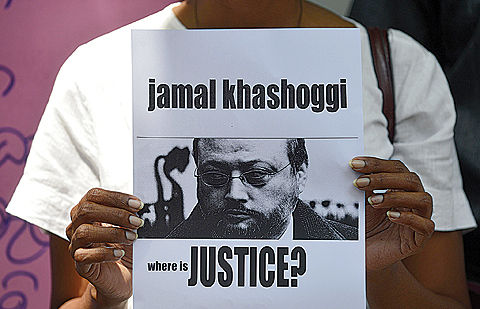 COLOMBO: A member of the Sri Lankan web journalist association holds a placard with the image of Saudi journalist Jamal Khashoggi during a demonstration outside the Saudi Embassy in Colombo yesterday. —AFP