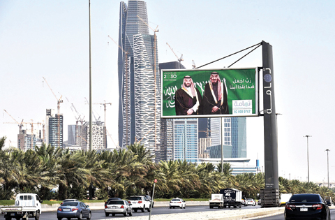 RIYADH: A picture taken on Monday shows portraits of Saudi King Salman and his son Crown Prince Mohammed bin Salman displayed one day before the Future Investment Initiative FII conference began. — AFP