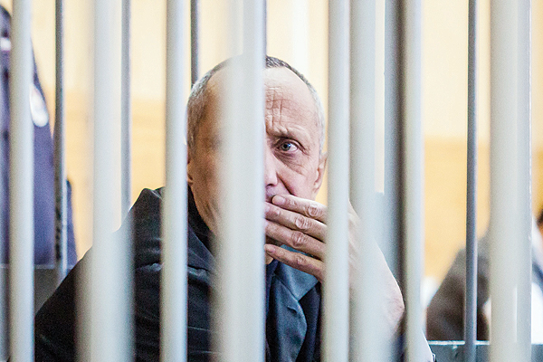 IRKUTSK: Mikhail Popkov sits inside a defendants’ cage during a court hearing in Irkutsk yesterday. A Siberian policeman who raped and killed women after offering them late-night rides was found guilty of dozens more murders - making him Russia’s most prolific serial killer of recent times. — AFP