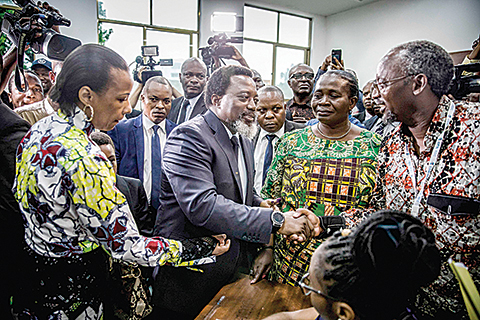 TOPSHOT - President of the Democratic Republic of Congo Joseph Kabila greets some electoral observers after casting his vote at the Insititut de la Gombe polling station during general elections in Kinshasa on December 30, 2018. - Voters in the Democratic Republic of Congo went to the polls on December 30 in elections that will shape the future of their vast, troubled country, amid fears that violence could overshadow the ballot. (Photo by Luis TATO / AFP)