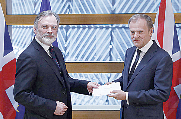 BRUSSELS: In this file photo, Britain's ambassador to the EU Tim Barrow (left) delivers British Prime Minister Theresa May's formal notice of the UK's intention to leave the bloc on March 29, 2017. The European Court of Justice ruled yesterday that Britain could halt withdrawal from the EU without seeking the approval of fellow member states, in a victory for anti-Brexit campaigners. _ AFP 