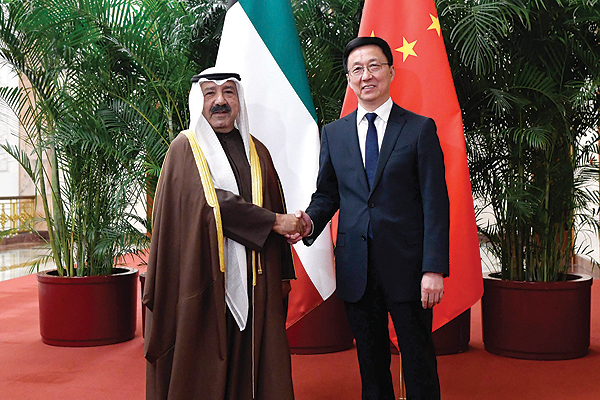 BEIJING: Chinese Vice Premier Han Zheng shakes hands with Kuwaiti First Deputy Prime Minister and Minister of Defense Sheikh Nasser Sabah Al-Ahmad Al-Sabah at the Great Hall of the People yesterday. - AFP 
