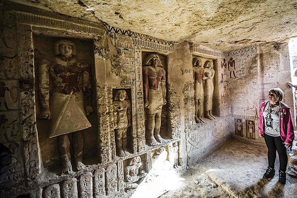SAQQARA, Egypt: Guests enter a newly-discovered tomb at the Saqqara necropolis yesterday. - AFP 