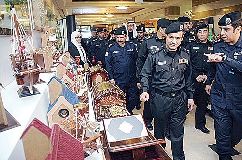 KUWAIT: Interior ministry officials tour an exhibition of handicrafts made by prisoners at Souq Sharq yesterday. —Photo by Yasser Al-Zayyat