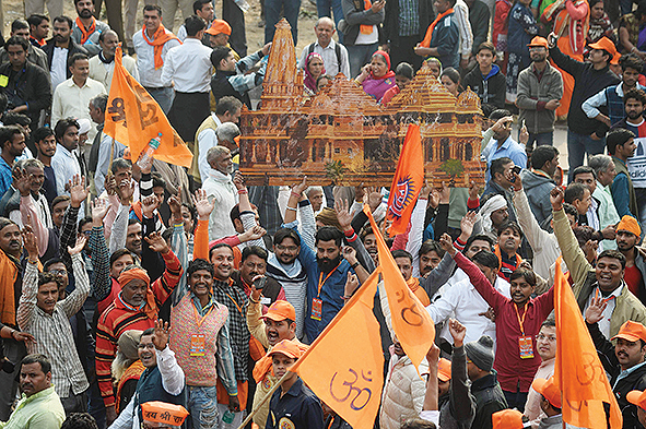 NEW DELHI: Indian Hindu hardliners hold a cutout of a temple as they participate in a rally yesterday. — AFP