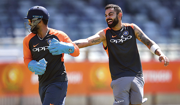 PERTH: India's cricket captain Virat Kohli (R) shares a lighter moment with teammate Rishabh Pant (L) during a training session in Perth yesterday. India take on Australia in the second cricket Test match starting tomorrow in Perth. - AFP