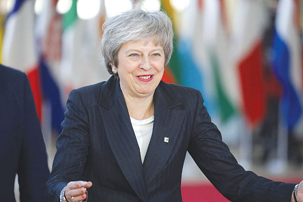 BRUSSELS: Britain's Prime Minister Theresa May gestures as she arrives in Brussels for a European Summit aimed at discussing the Brexit deal, the long-term budget and the single market.-AFP 
