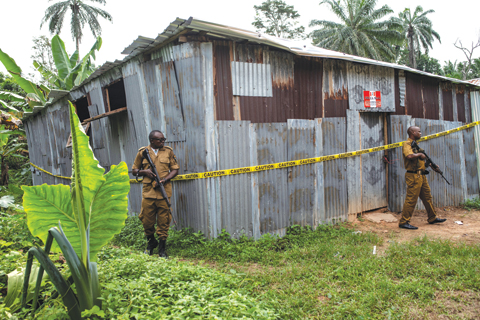 National Drug Law Enforcement Agency (NDLEA) officials stand on guard, securing the perimeter around a busted clandestine methamphetamine lab on November 22, 2018 in Obinugwu village in southeast Nigeria. - AFP 