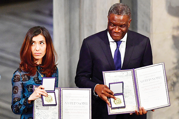 nOSLO: Nobel Peace Prize laureates Yazidi activist Nadia Murad and Congolese doctor Denis Mukwege pose with their Nobel Peace Prizes during the award ceremony yesterday at the City Hall. - AFP nn nnnn