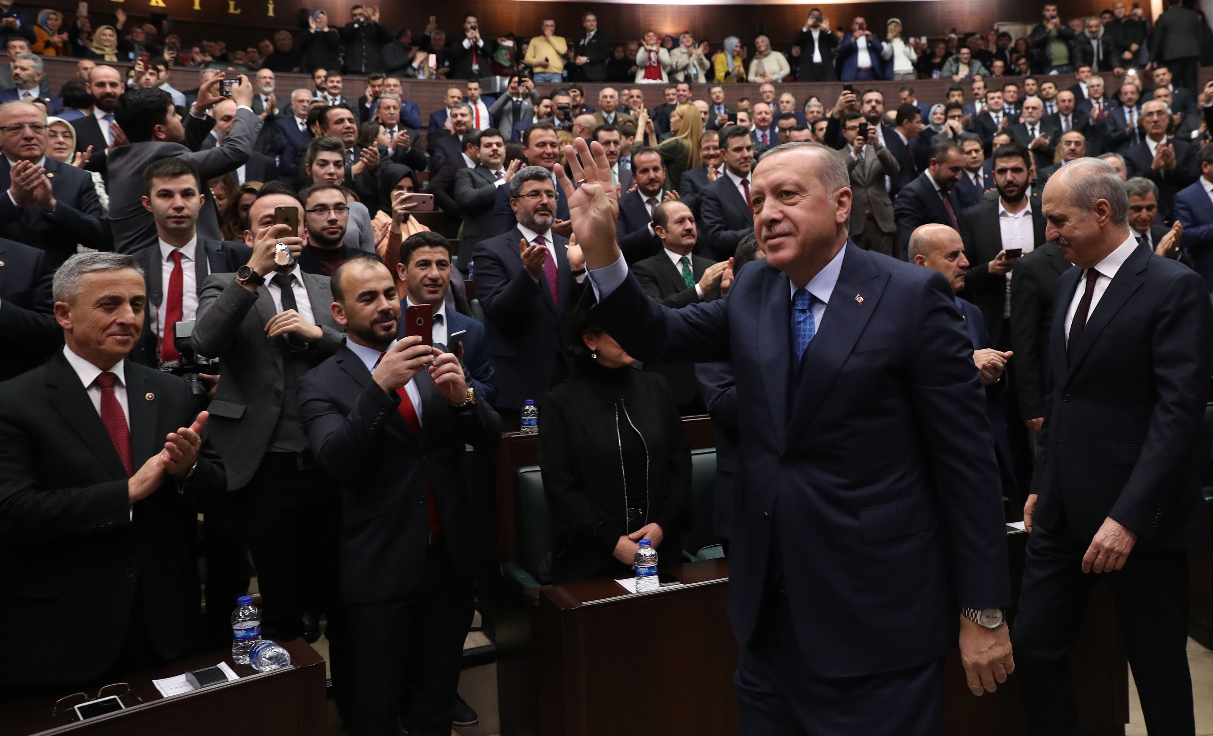 The President of Turkey and leader of Turkey's ruling Justice and Development (AK) Party Recep Tayyip Erdogan gestures to his supporters during his party's parliamentary group meeting at the Grand National Assembly of Turkey in Ankara, on December 25, 2018. (Photo by Adem ALTAN / AFP)