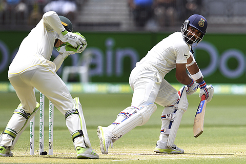 PERTH: India's batsman Ajinkya Rahane is caught behind by Australia's wicketkeeper Tim Paine (L) on the third day of the second cricket Test match in Perth yesterday. - AFP
