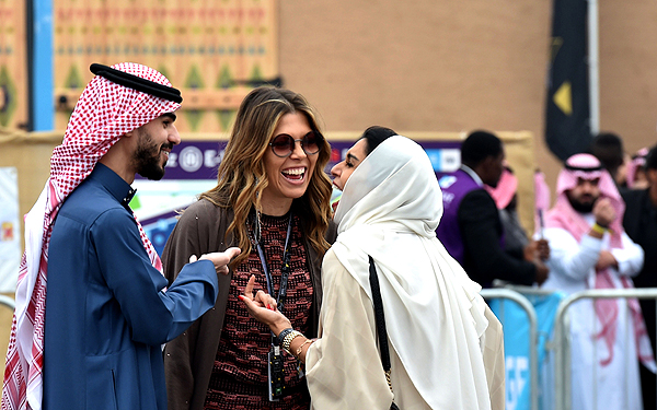 RIYADH: People chat prior to the 2018 Saudia Ad Diriyah E-Prix Formula E Championship yesterday. - AFP