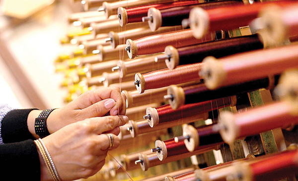 close-up view of reels of thread in the laboratory of Antico setificio Fiorentino ancient silk factory in Florence