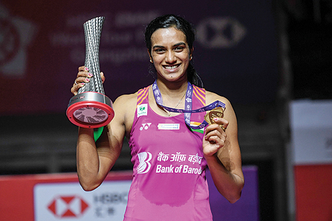 GUANGZHOU: Winner Sindhu Pusarla of India poses with her trophy after the women's singles final match at the 2018 BWF World Tour Finals badminton competition in Guangzhou in southern China's Guangdong province yesterday. - AFP