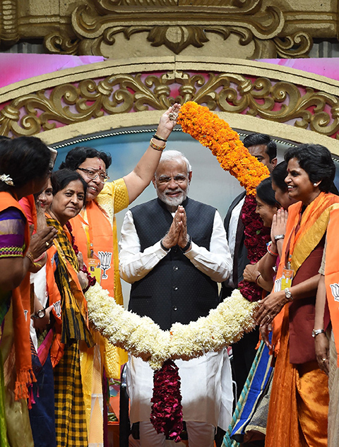 Indian Prime Minister Narendra Modi (C) gestures during the Bhartiya Janta Party (BJP) Mahila Morcha Sammelan (women convention) in Adalaj, some 30 kms from Ahmedabad on December 22, 2018. (Photo by SAM PANTHAKY / AFP)