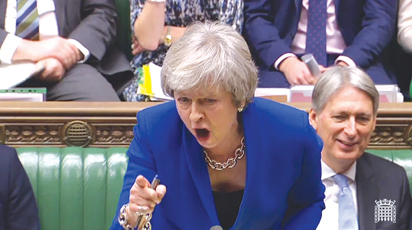 LONDON: A video grab from footage broadcast shows Britain’s Prime Minister Theresa May as she tells makes a joke about the opposition Labor party leader Jeremy Corbyn’s failure to demand a no-confidence vote against her government. — AFP