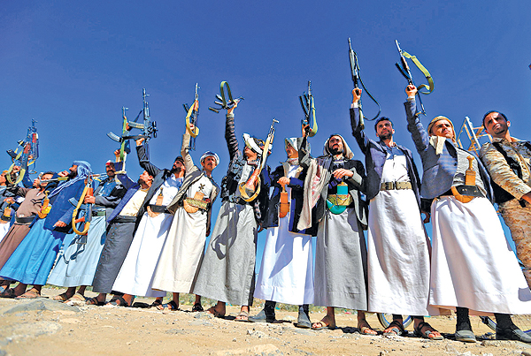 SANAA: Armed Yemeni men hold their weapons as they gather in the capital Sanaa to show their support to the Shiite Houthi movement against the Saudi-led intervention yesterday. — AFP