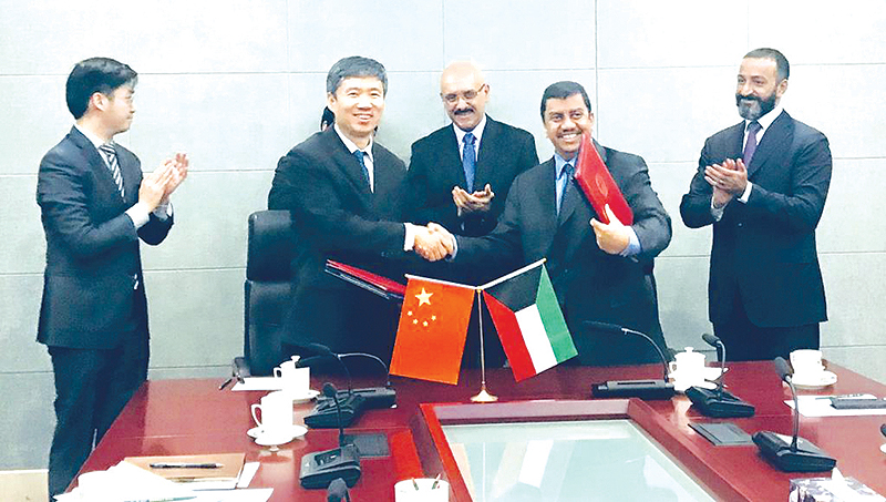 BEIJING: Kuwaiti and Chinese officials celebrate signing the agreement. - KUNA