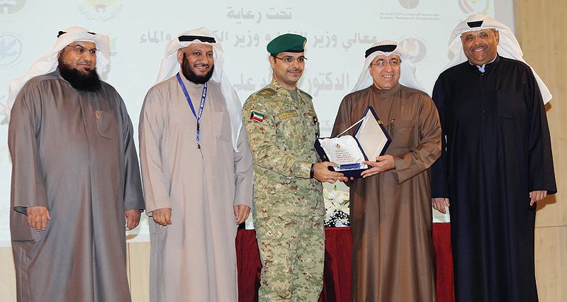 KUWAIT: Ministry of Electricity and Water’s undersecretary Mohammed Bushehri (second from right) honorsnKuwait National Guard in the ministry’s second conservation forum. — Photo by Joseph Shagra
