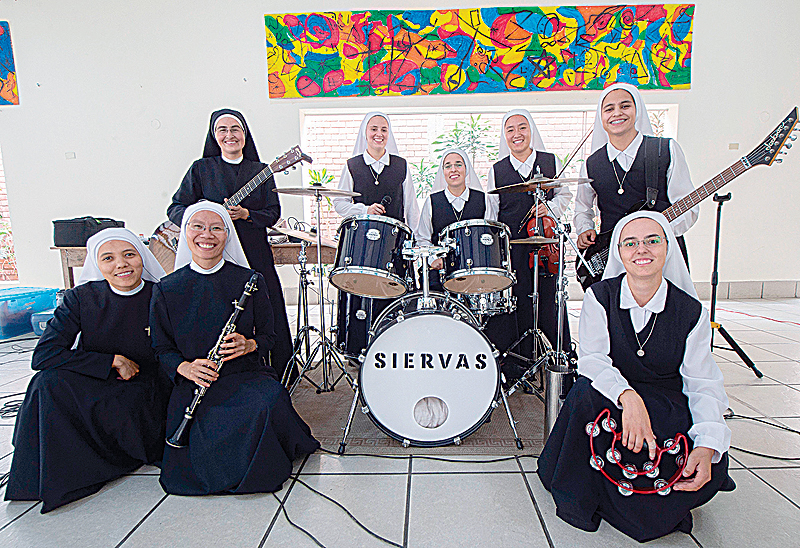 Eight of the nine members of religious musical band “Siervas” (Servants), known as the “rock nuns” pose for a picture during a rehearsal in Lima.—AFP photosn