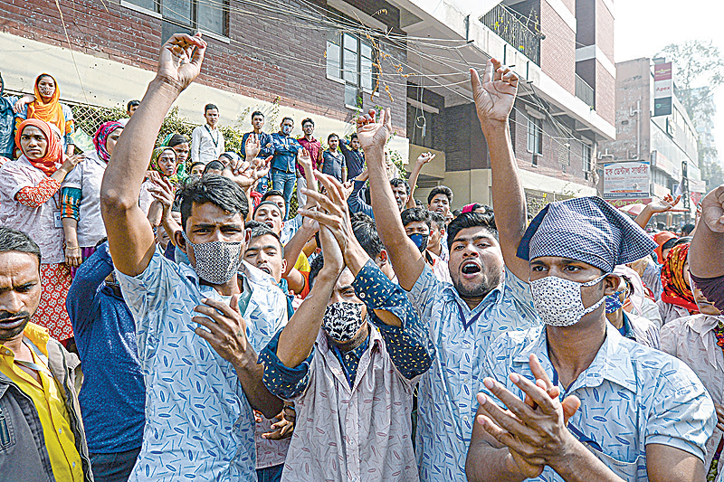DHAKA: Bangladeshi garment workers shout slogans during a demonstration to demand higher wages in Dhaka. The readymade garment (RMG) workers staged the demonstration for the fifth consecutive day in Dhaka yesterday. —AFP