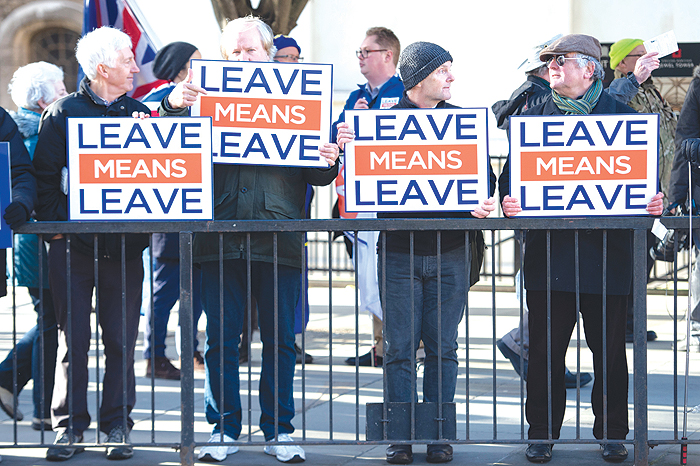 LONDON: Activists hold up placards from the Leave Means Leave Pro-Brexit campaign group outside the Houses of Parliament. — AFP