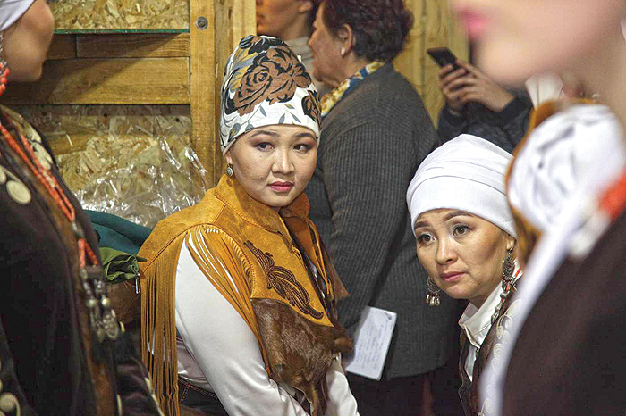 Elzat Kazakbaeva (left) and Aida Sooronbaeva (right), bride kidnapping survivors, wait in the backstage for a fashion show organized by fashion designer Zamira Moldosheva, part of a public movement against bride kidnapping and domestic violence, Bishkek, Kyrgyzstan.