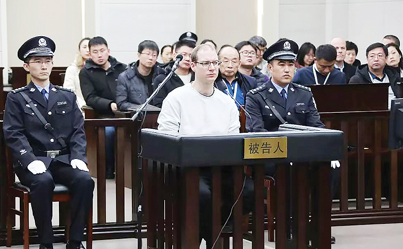 DALIAN, China: This photograph taken and released by the Intermediate Peoples’ Court of Dalian on January 14, 2019 shows Canadian Robert Lloyd Schellenberg (C) during his retrial on drug trafficking charges in the court. — AFP