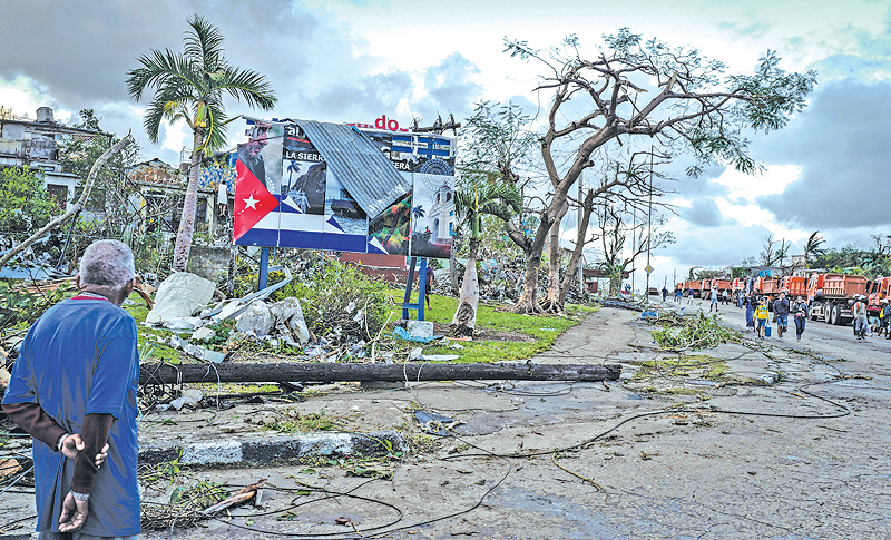 HAVANA: A resident of tornado-hit Regla neighborhood looks at destroyed buildings. — AFP
